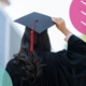 Graduate wearing a cap and gown with their back to the camera, considering their career path after university